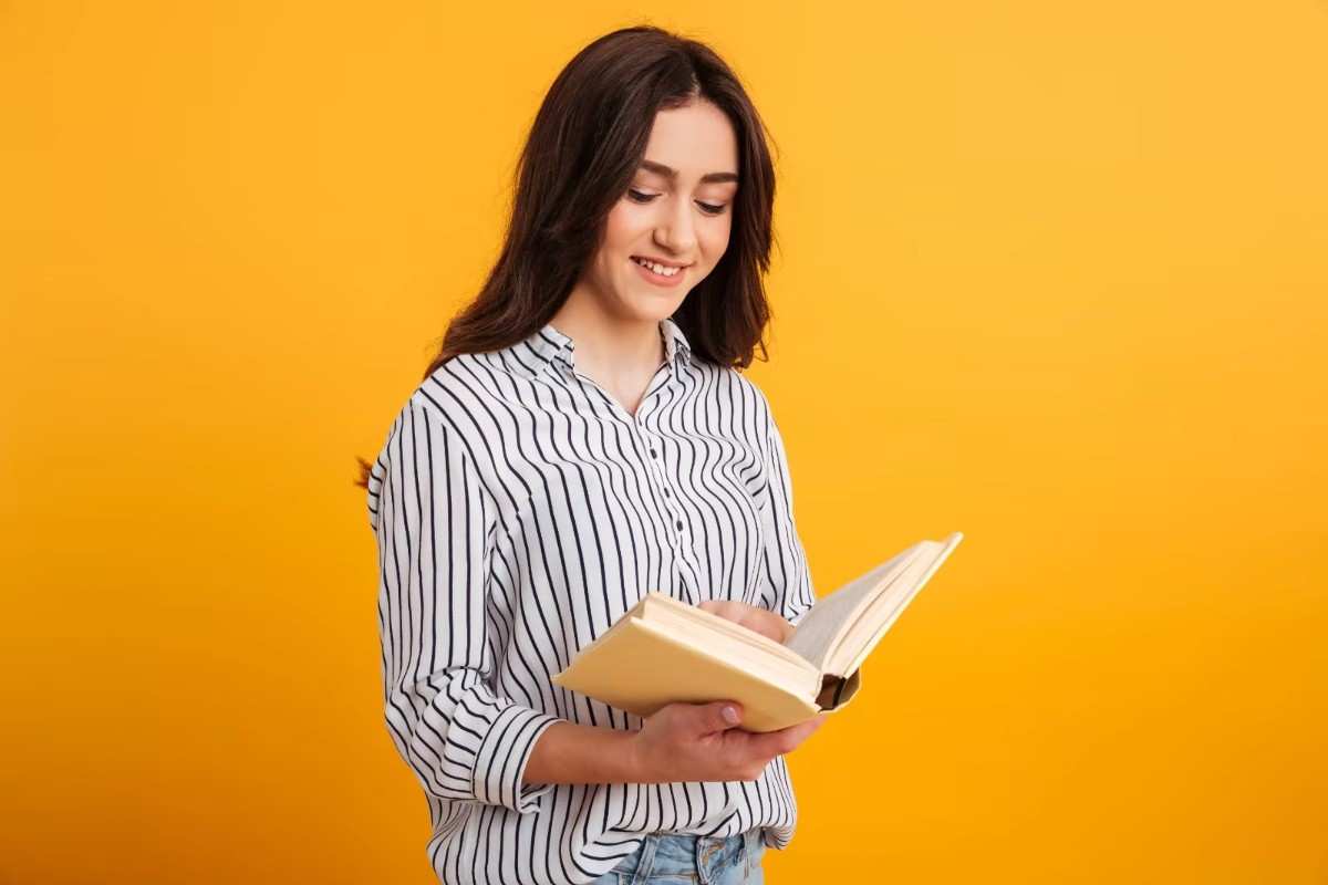 A lovely woman reading a book while glowing and feeling motivated